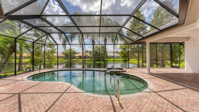 view of pool with a patio, a lanai, an in ground hot tub, and a water view