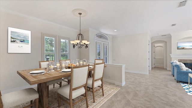 dining area featuring an inviting chandelier and crown molding