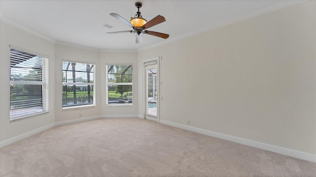 empty room with light carpet, crown molding, and plenty of natural light