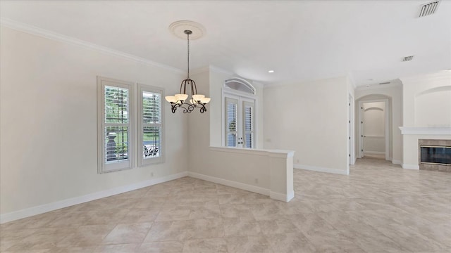 unfurnished room featuring ornamental molding and a notable chandelier