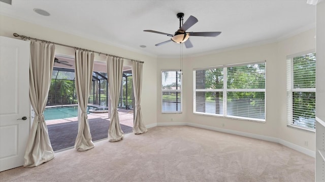 empty room with light carpet, ornamental molding, and plenty of natural light