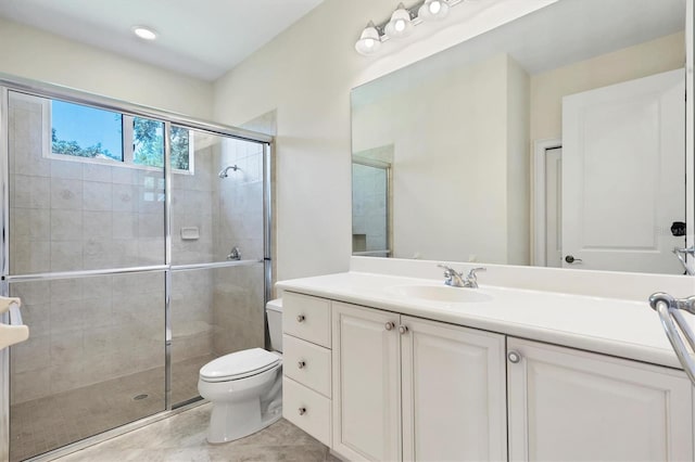 bathroom featuring vanity, toilet, tile patterned floors, and walk in shower