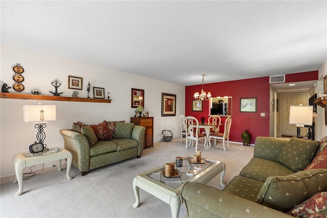 carpeted living room featuring a textured ceiling and a notable chandelier