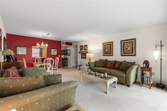 living room with light colored carpet, a notable chandelier, and a textured ceiling