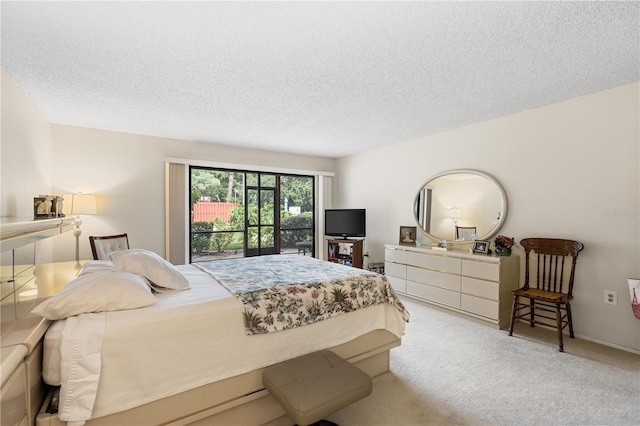 bedroom with a textured ceiling, light carpet, and access to outside