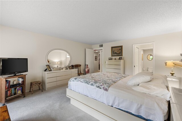 carpeted bedroom with a textured ceiling