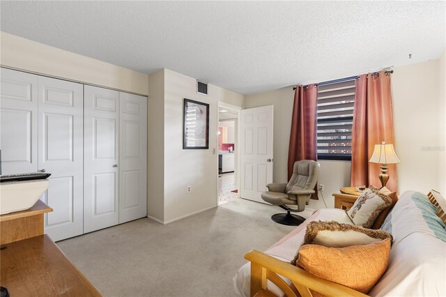 carpeted living room featuring a textured ceiling