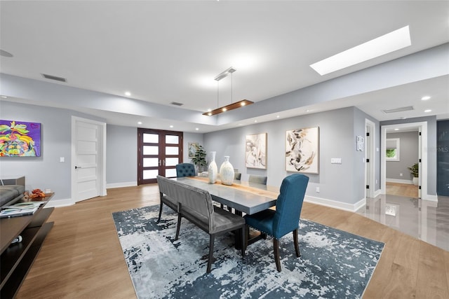 dining area featuring french doors and light hardwood / wood-style floors