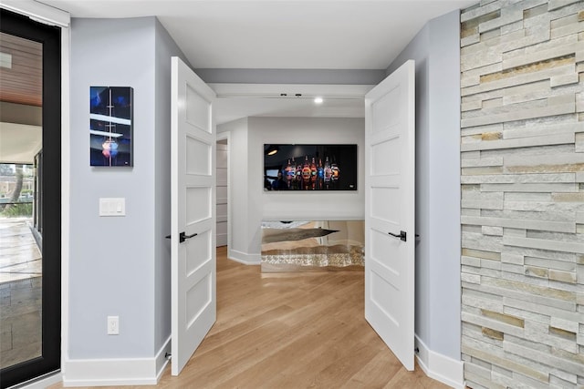 hall with light hardwood / wood-style flooring