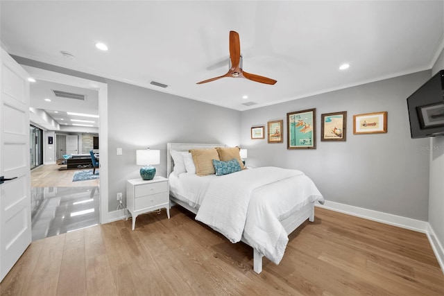 bedroom featuring light wood-type flooring, crown molding, and ceiling fan