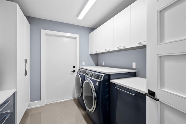 washroom with washer and clothes dryer and cabinets