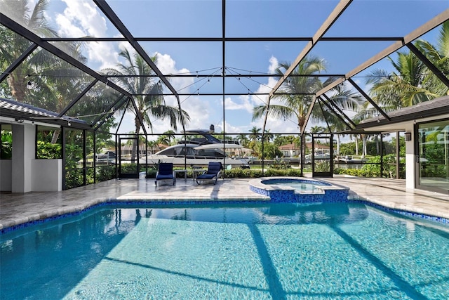 view of swimming pool with glass enclosure, an in ground hot tub, and a patio