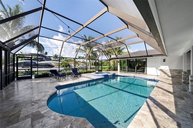 view of swimming pool featuring a patio and a lanai