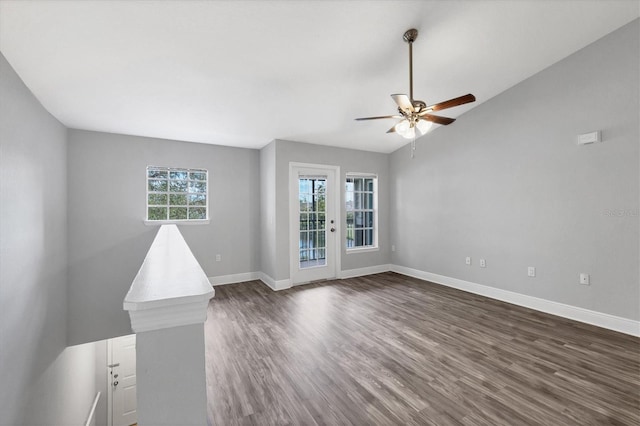 empty room featuring dark wood-type flooring, ceiling fan, and vaulted ceiling