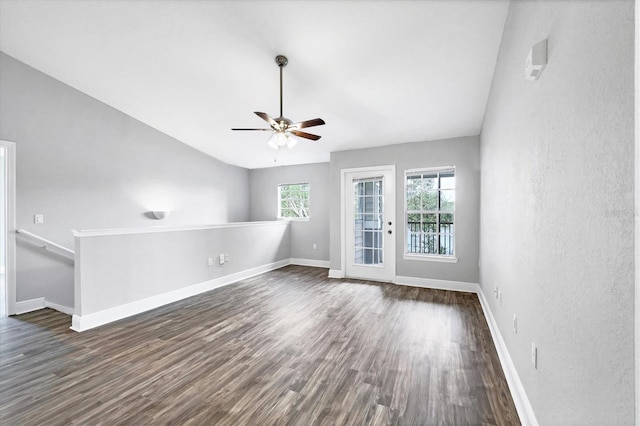 unfurnished living room with lofted ceiling, ceiling fan, and dark hardwood / wood-style flooring