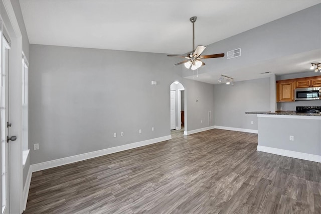 unfurnished living room featuring dark wood-type flooring, ceiling fan, and lofted ceiling