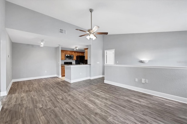 unfurnished living room featuring lofted ceiling, ceiling fan, and dark hardwood / wood-style floors