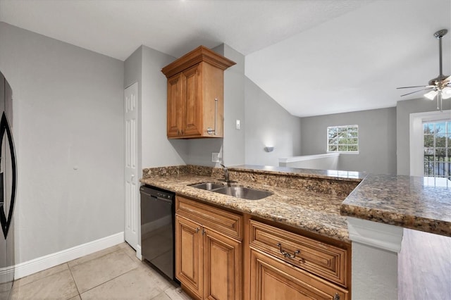 kitchen with dark stone countertops, sink, ceiling fan, black dishwasher, and light tile patterned flooring