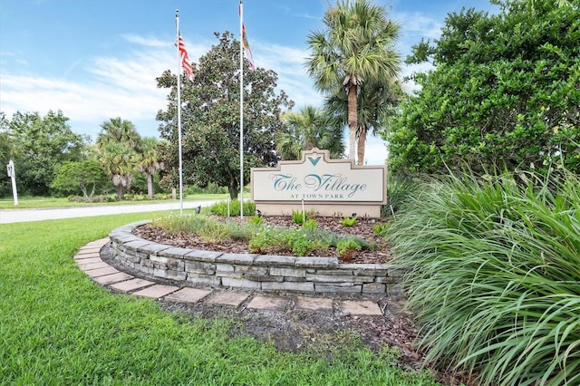 community / neighborhood sign with a lawn