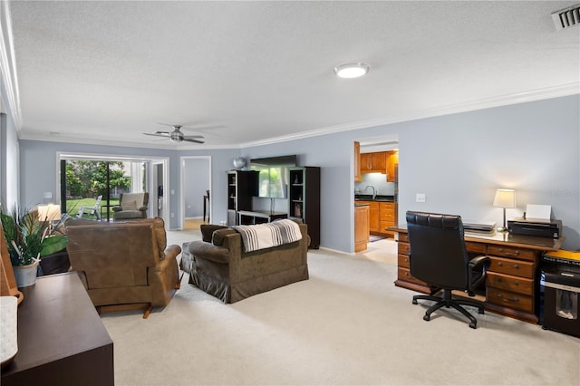 office with light carpet, sink, ceiling fan, ornamental molding, and a textured ceiling