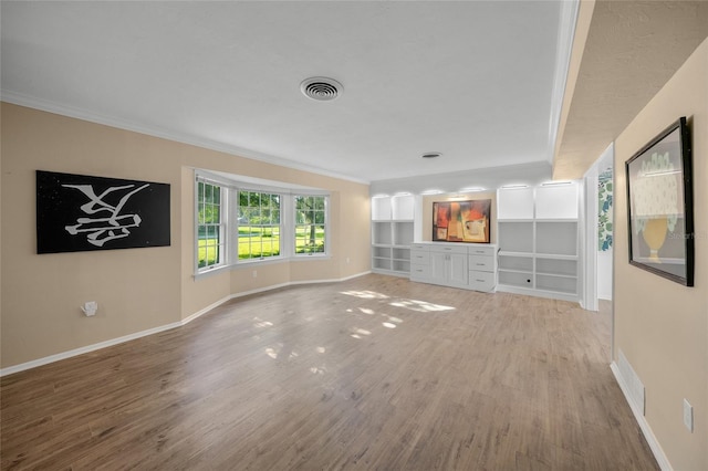 unfurnished living room with crown molding and light hardwood / wood-style floors