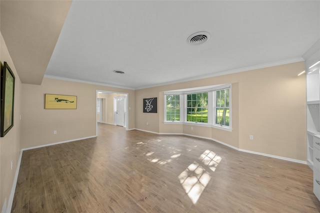 unfurnished living room with light hardwood / wood-style floors and crown molding