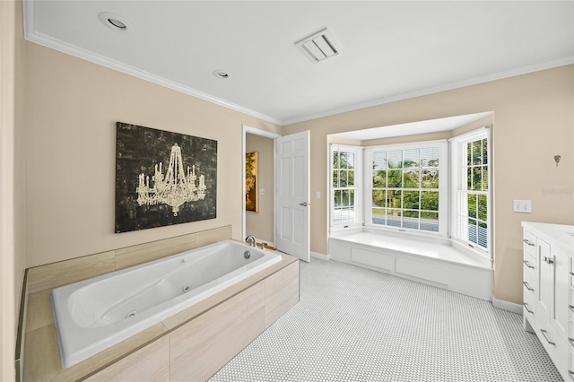 bathroom featuring tile patterned floors, tiled bath, vanity, and crown molding