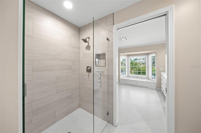 bathroom featuring walk in shower, vanity, and tile patterned floors