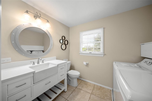 bathroom featuring vanity, tile patterned flooring, toilet, and washer and dryer