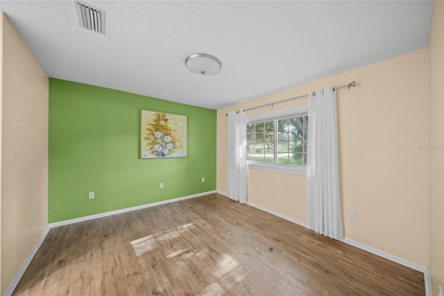 spare room with light hardwood / wood-style flooring