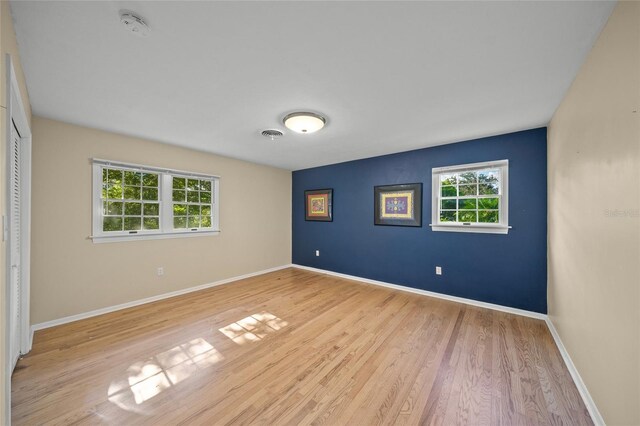 unfurnished bedroom with light hardwood / wood-style floors and a closet