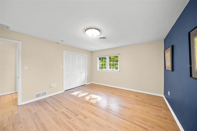 unfurnished bedroom featuring a closet and light hardwood / wood-style floors