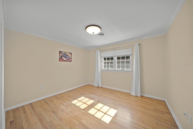 unfurnished bedroom with ornamental molding and light wood-type flooring