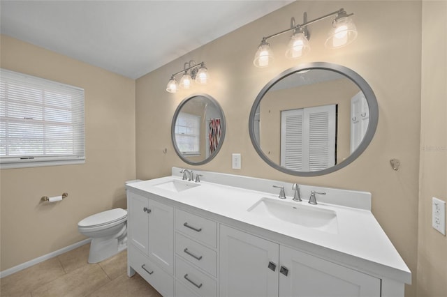 bathroom with tile patterned flooring, vanity, and toilet