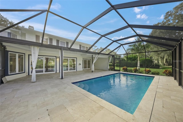 view of pool with a patio and a lanai