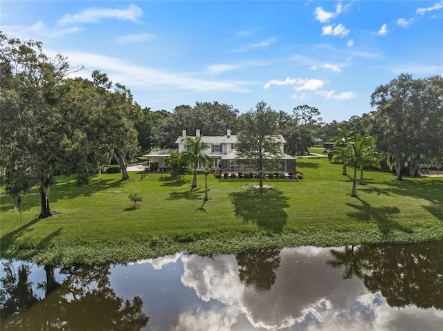 exterior space with a lawn and a water view