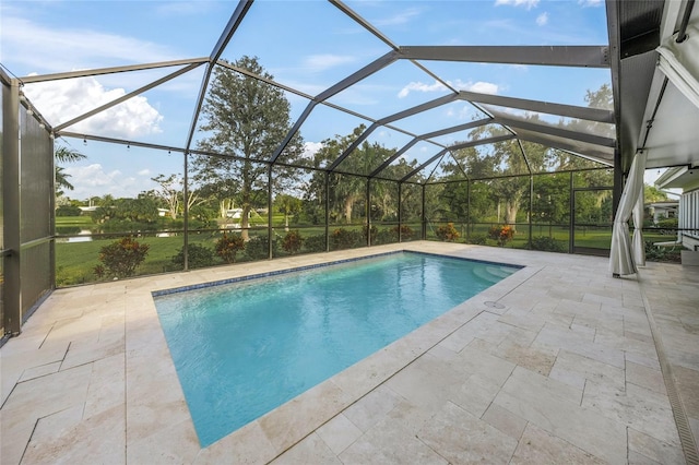 view of swimming pool with glass enclosure and a patio area