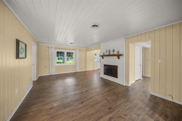 unfurnished living room featuring wooden walls, a fireplace, dark wood-type flooring, and wooden ceiling