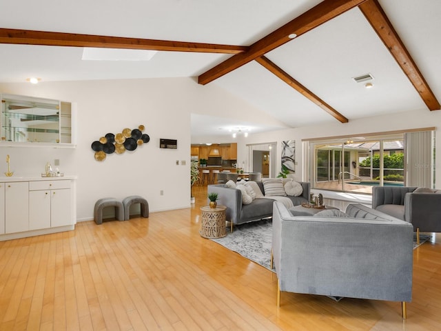 living room with light wood-type flooring and lofted ceiling with skylight