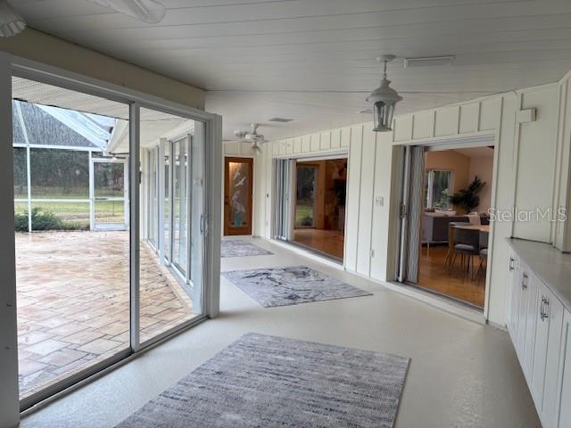 doorway with wood walls and wood ceiling