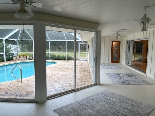 view of swimming pool featuring ceiling fan