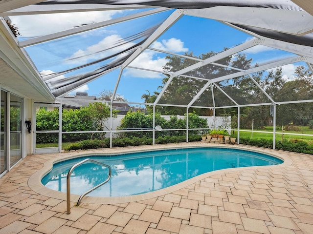 view of pool with a lanai and a patio