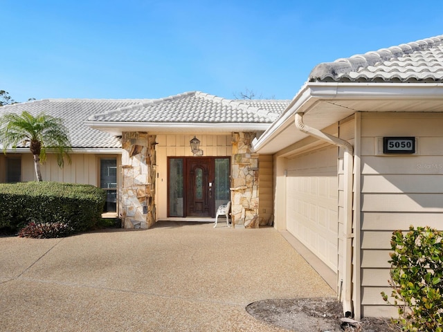 view of exterior entry with a garage