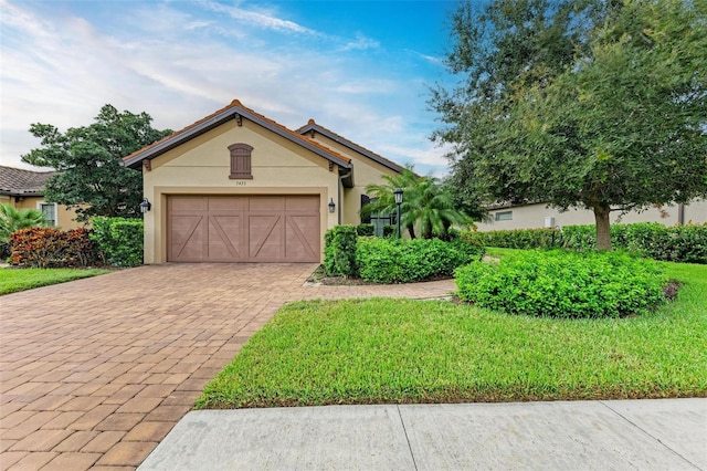 view of front of home with a garage and a front yard