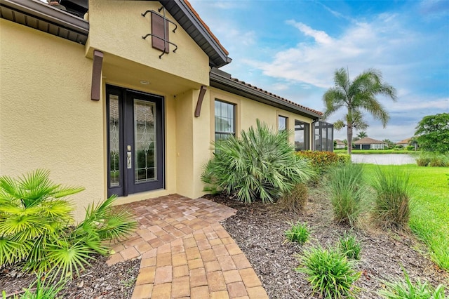 doorway to property featuring a yard and a water view