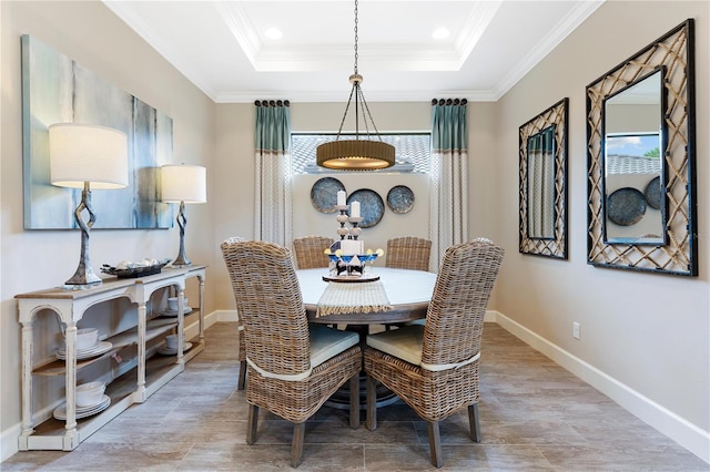 dining room featuring a tray ceiling and ornamental molding