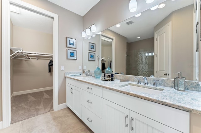 bathroom featuring vanity, tile patterned flooring, and a shower with door