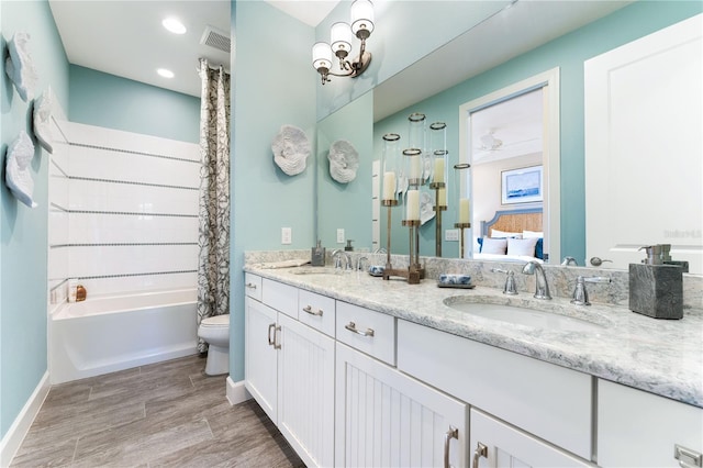 full bathroom featuring shower / bath combo with shower curtain, hardwood / wood-style floors, toilet, and vanity