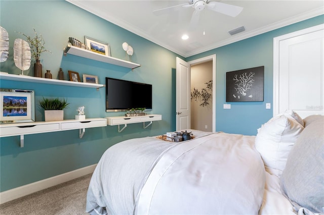 bedroom with ceiling fan, crown molding, and carpet floors