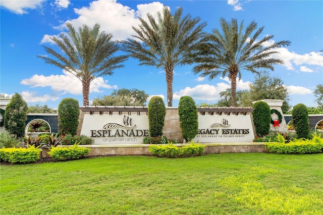 community sign featuring a yard